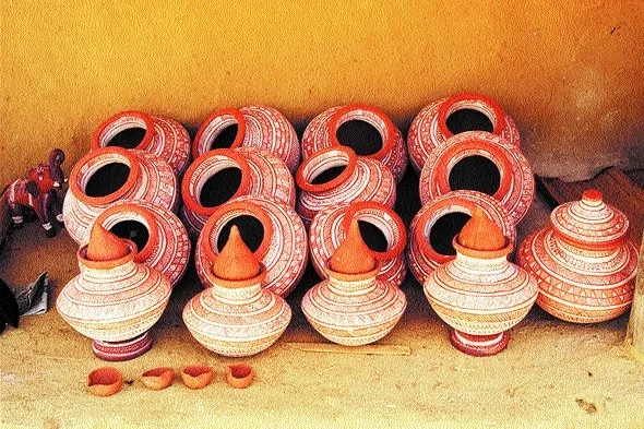 Open-air dung-fired kiln firing terracotta pottery in Kutch Gujarat